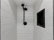 Updated shower featuring white tiled walls, and modern black shower head at 2230 Jamaica St, Aurora, CO 80010