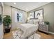 Comfortable bedroom with hardwood floors, stylish decor, and a bright window at 8360 Snake River St, Littleton, CO 80125