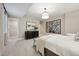 Bright bedroom featuring neutral tones, modern lighting, dresser, and walk-in closet entrance at 8360 Snake River St, Littleton, CO 80125
