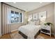 Cozy bedroom with a large window, neutral decor, and stylish artwork at 8360 Snake River St, Littleton, CO 80125