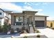 Charming home featuring stone accents, a covered porch, and a well-maintained front yard at 8360 Snake River St, Littleton, CO 80125