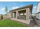 Charming covered patio with stone pillars, a dining set, and a view of the yard at 8360 Snake River St, Littleton, CO 80125