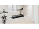 Finished basement area with neutral carpet, a treadmill, and a stationary bike at 9124 E 29Th Pl, Denver, CO 80238