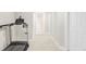 Finished basement hallway with neutral carpet, a treadmill, and neutral paint at 9124 E 29Th Pl, Denver, CO 80238