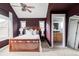 Spacious bedroom featuring a ceiling fan, ensuite bathroom, and comfortable carpet at 9124 E 29Th Pl, Denver, CO 80238