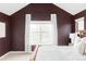 Bedroom with a large window and maroon colored walls at 9124 E 29Th Pl, Denver, CO 80238