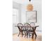Dining room with a wooden table, chairs, decorative chandelier, and natural light at 9124 E 29Th Pl, Denver, CO 80238