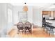 Dining area features modern chandelier, kitchen, and an open design at 9124 E 29Th Pl, Denver, CO 80238