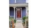 Inviting front door with a charming porch and vibrant landscaping at 9124 E 29Th Pl, Denver, CO 80238