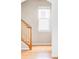 Hallway with hardwood floors, wooden staircase, and window with natural light at 9124 E 29Th Pl, Denver, CO 80238
