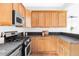 Kitchen with ample cabinet space, updated appliances, and functional layout at 9124 E 29Th Pl, Denver, CO 80238