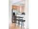 Kitchen bar featuring countertops and bar stools with stainless steel refrigerator at 9124 E 29Th Pl, Denver, CO 80238