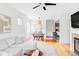 Open-concept living room with dining area and kitchen access, featuring hardwood floors at 9124 E 29Th Pl, Denver, CO 80238