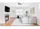 Bright living room features a fireplace, hardwood floors, and a large window at 9124 E 29Th Pl, Denver, CO 80238