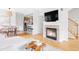 Spacious living room with hardwood floors, fireplace, and open access to dining and kitchen at 9124 E 29Th Pl, Denver, CO 80238