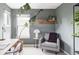 Home office with a gray armchair, large window, and hardwood shelf at 9124 E 29Th Pl, Denver, CO 80238