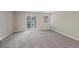 Bright bedroom featuring sliding glass door access and plush carpeting at 2862 W Warren Ave, Denver, CO 80219