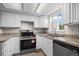View of the bright kitchen with stainless steel appliances and double sink at 2862 W Warren Ave, Denver, CO 80219