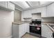 Bright kitchen featuring light cabinets, stainless appliances and attractive countertops at 2862 W Warren Ave, Denver, CO 80219