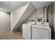 Functional laundry room featuring standard washer and dryer hookups on a neutral tile floor at 2862 W Warren Ave, Denver, CO 80219