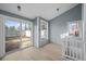 Bright living room featuring light colored floors and a sliding glass door at 2862 W Warren Ave, Denver, CO 80219