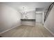 Open-concept living space with hardwood floors, stylish lighting, and a breakfast bar at 2862 W Warren Ave, Denver, CO 80219