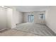Open living room with carpet, sliding glass door, and natural lighting at 2862 W Warren Ave, Denver, CO 80219