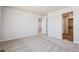 Spacious bedroom featuring plush carpeting and a doorway to another room at 3352 N Highlands Creek Pkwy, Aurora, CO 80019