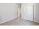 Bedroom with plush carpet, closet, and a door open to an adjoining space at 3352 N Highlands Creek Pkwy, Aurora, CO 80019