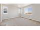 Bright bedroom with large windows and neutral carpeting, ready for personalization at 3352 N Highlands Creek Pkwy, Aurora, CO 80019