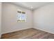 A bright bedroom featuring a large window that offers a view of the outdoors at 3352 N Highlands Creek Pkwy, Aurora, CO 80019