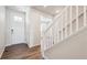 Bright entryway with a white door, wood floors, and a staircase with white railing at 3352 N Highlands Creek Pkwy, Aurora, CO 80019