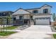 Charming two-story home with a welcoming front porch, attached two-car garage and newly landscaped yard at 3352 N Highlands Creek Pkwy, Aurora, CO 80019
