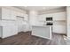 Modern kitchen features white cabinets, stainless steel appliances, and a center island at 3352 N Highlands Creek Pkwy, Aurora, CO 80019