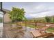 Expansive wood back deck with wood railing and two chaise lounges overlooking the fenced in back yard at 22367 Quail Run Dr, Parker, CO 80138