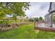 Large backyard with terraced retaining wall and wooden deck with built in seating at 22367 Quail Run Dr, Parker, CO 80138