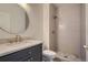 Modern bathroom features a vanity sink with stylish finishes, complemented by a step-in shower with elegant tile at 22367 Quail Run Dr, Parker, CO 80138