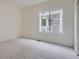 Bright and airy bedroom with neutral tones, a large window, and plush carpeting at 22367 Quail Run Dr, Parker, CO 80138