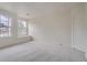 A bright bedroom with two windows, plush carpet, and neutral paint at 22367 Quail Run Dr, Parker, CO 80138
