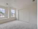 An airy bedroom with a built-in window seat, double windows, closet, and plush carpet at 22367 Quail Run Dr, Parker, CO 80138