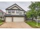 Traditional two-story home with three-car garage, stone accents, and a well-manicured lawn at 22367 Quail Run Dr, Parker, CO 80138