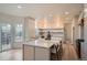 Bright kitchen features stainless appliances, an island with seating and custom cabinets for an elegant, modern style at 22367 Quail Run Dr, Parker, CO 80138
