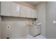 Well-lit laundry room features a mosaic tile floor, built-in cabinets, and modern fixtures at 22367 Quail Run Dr, Parker, CO 80138
