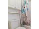 Close up of a toilet and bath with beach themed shower curtain at 2574 E Geddes Ave, Centennial, CO 80122