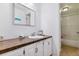 Bright bathroom featuring a white vanity with a solid surface countertop and shower-tub combo at 2574 E Geddes Ave, Centennial, CO 80122