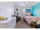 Cozy bedroom featuring a comfortable bed, a stylish desk, and a bright window at 2574 E Geddes Ave, Centennial, CO 80122