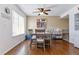 Dining area features hardwood floors, modern table, and a view through the window at 2574 E Geddes Ave, Centennial, CO 80122