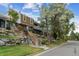 Charming townhouse exterior with rock landscaping and wooden stairs leading to the entrance at 2574 E Geddes Ave, Centennial, CO 80122