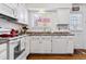 Functional kitchen features white cabinets, essential appliances, and wood flooring at 2574 E Geddes Ave, Centennial, CO 80122