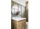 Modern bathroom with a round mirror and marble vanity at 4659 Wyandot St, Denver, CO 80211